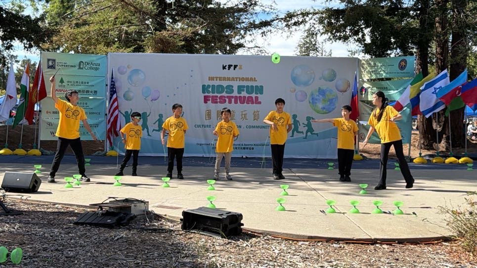 FCS students performing with diabolos on an outdoor festival stage.