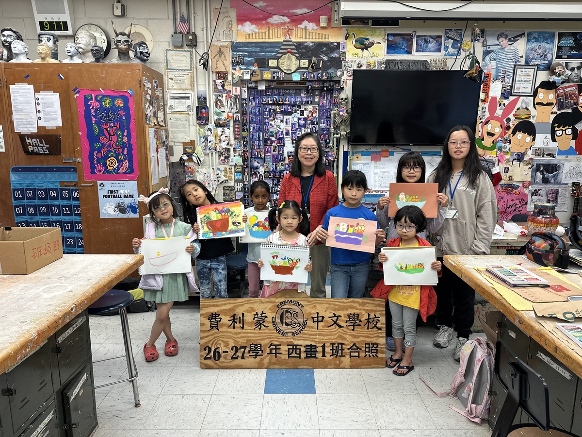 Painting 1 class students holding up their artwork alongside their teacher on Picture Day.