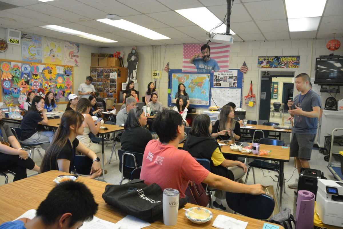 Teachers and staff gathered in a classroom for the FCS staff meeting.